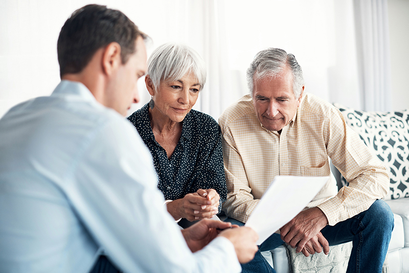 Senior aged couple reviewing financial paperwork